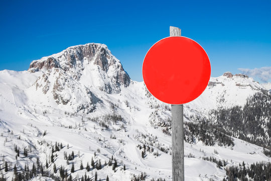 Red ski slope sign in mountain ski resort in the Alps in Austria.