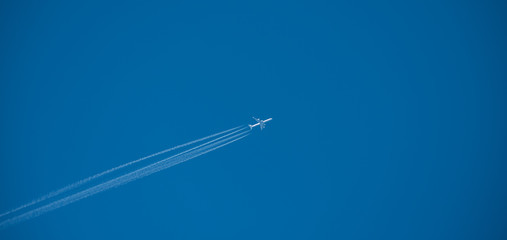 Shot of a jet plane high in the blue sky