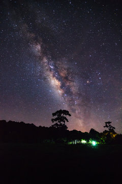 milky way and silhouette of Tree with cloud. Long exposure photo