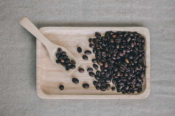 fresh coffee beans and wood spoon prepared on the desktop