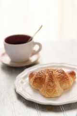 Croissant and coffee cup
