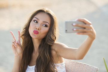 Closeup portrait young beatiful girl taking photo selfie on smar