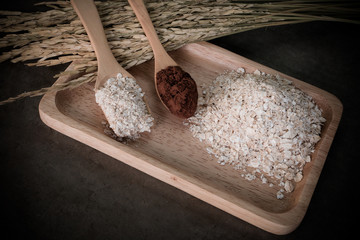 Oat flakes mixing with coco powder on desktop, prepare for healthy.