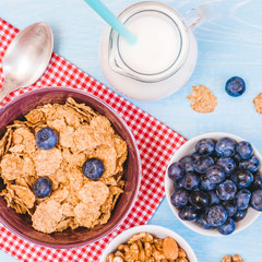 healthy breakfast, cornflakes blueberry and milk, nuts, almond with text space close-up