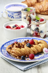 Braided danish bun made of puff pastry decorated with fresh frui