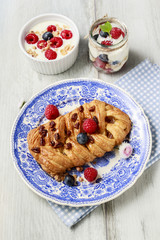 Braided danish bun made of puff pastry decorated with fresh frui