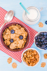 healthy breakfast, cornflakes blueberry and milk, nuts, almond with text space close-up