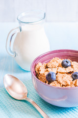 healthy breakfast, cornflakes blueberry and milk, nuts, almond with text space close-up