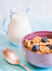 healthy breakfast, cornflakes blueberry and milk, nuts, almond with text space close-up