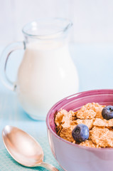 healthy breakfast, cornflakes blueberry and milk, nuts, almond with text space close-up