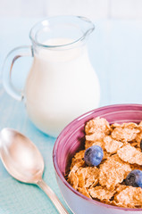 healthy breakfast, cornflakes blueberry and milk, nuts, almond with text space close-up