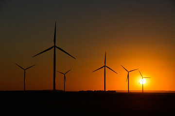 Windwheels and a beautiful sunset seen in rural France