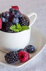 close up of raspberries, blackberries, blueberries and mint leav