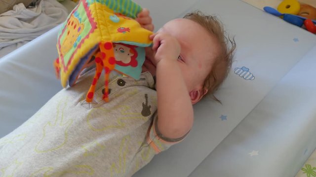 Portrait of cute baby reading a picture book