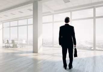 Fototapeta premium Businessman in office . Mixed media