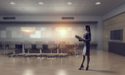 Fototapeta premium Businesswoman in modern office interior . Mixed media