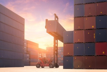 Forklift truck lifting cargo container in shipping yard or dock yard for logistic industry
