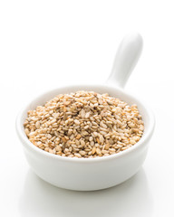 porcelain bowl filled with sesame, isolated