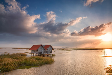 abadonded hut on dam with nice sky