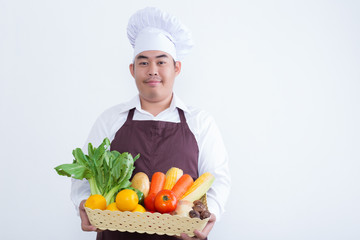 Portrait of a chef holding fruit and vegetable