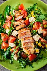 Fresh salad with chicken breast, arugula and tomato