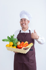 Portrait of a chef holding fruit and vegetable