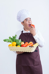 Portrait of a chef holding fruit and vegetable