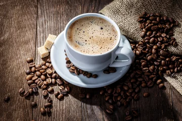 Keuken foto achterwand Koffie white mug of coffee beans on a wooden background
