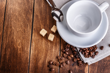 white cup of coffee with roasted beans