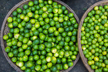 Lime fruits on the big plate on local market