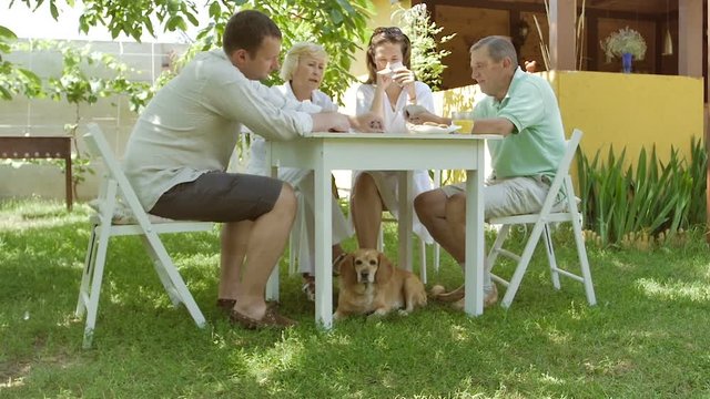 People have fun at the cottage in the garden.