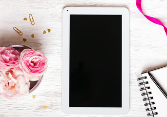 Flowers, notepad and tablet with empty screen