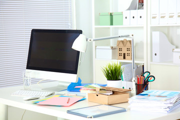 Designer working desk with computer and paperwork
