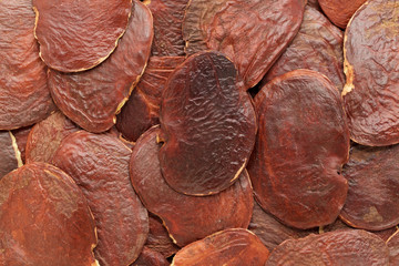 Organic Bastard Teak or Palaash (Butea monosperma) seeds. Macro close up background texture. Top view.