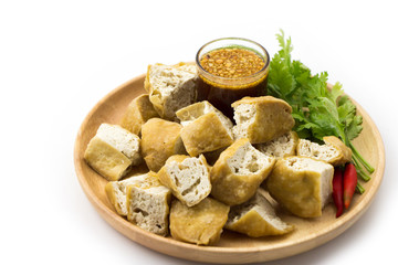 Fried tofu in wooden dish white background 