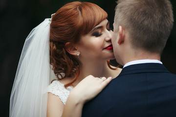 The lovely couple in love embracing in the park