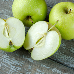 Green apples on the old boards