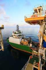 Supply boat transfer cargo to oil and gas industry and moving cargo from the boat to the platform,...