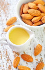 almond essential oil and almond in bowl