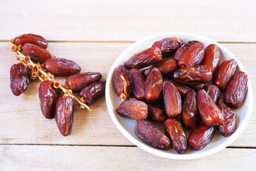 Top view of pile of dried date fruit on a wooden table.