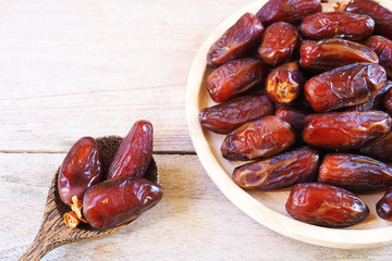 Top view of pile of dried date fruit on a wooden table.