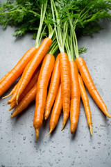 Fresh carrots on the gray backgrounds.