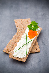 Crispbread with soft cheese with herbs and bacon.