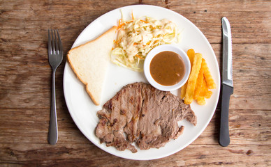 Top view rib eye steak on wooden table 