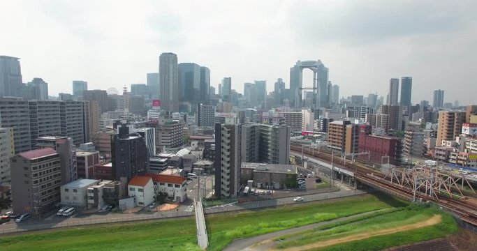 Acending aerial reveal shot of Osaka CIty Metropolitan area Japan 2nd largest city 