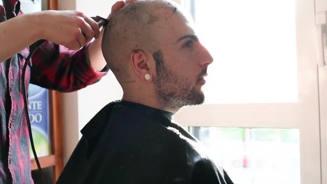 Woman barber cutting hair using razor - beauty, hair style concept