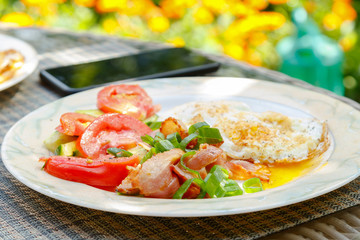 Roasted eggs with bacon and vegetables