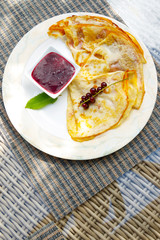 Pancakes with currant berries and jam