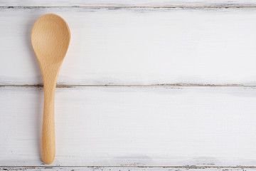 Spoon on wood white.