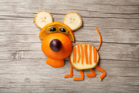 Funny orange tiger made on wooden background